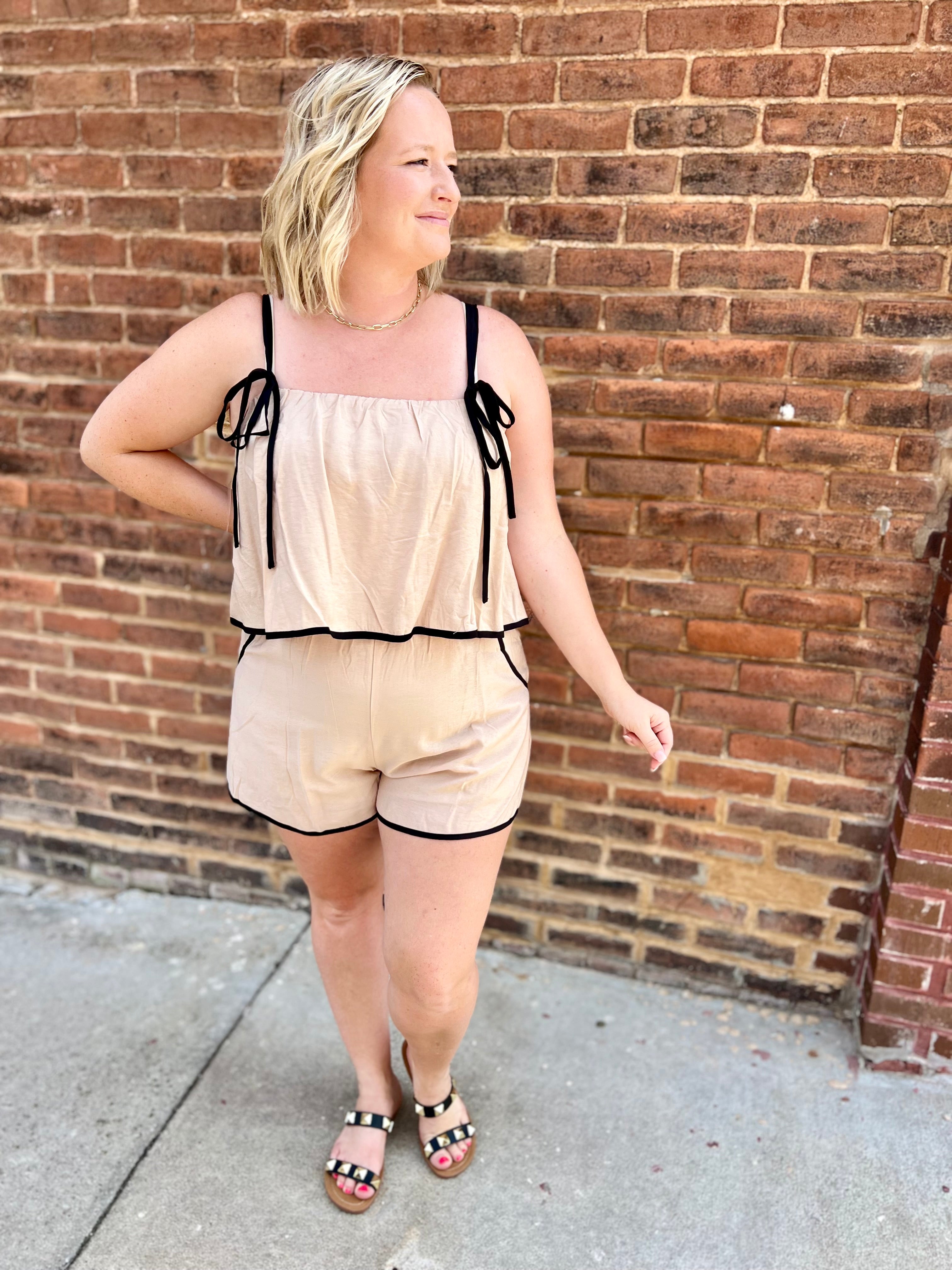 Light taupe romper with black trimming